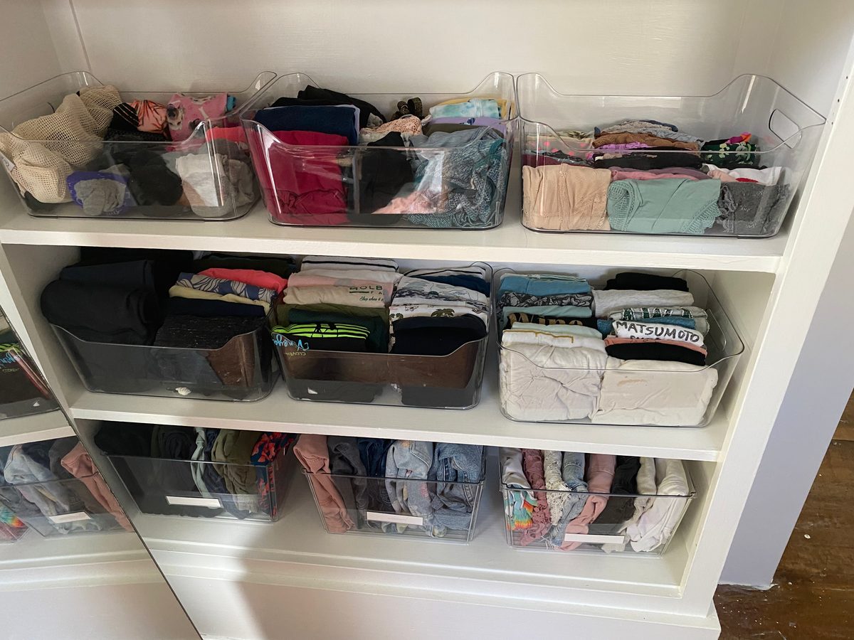 Organized closet shelves with bins